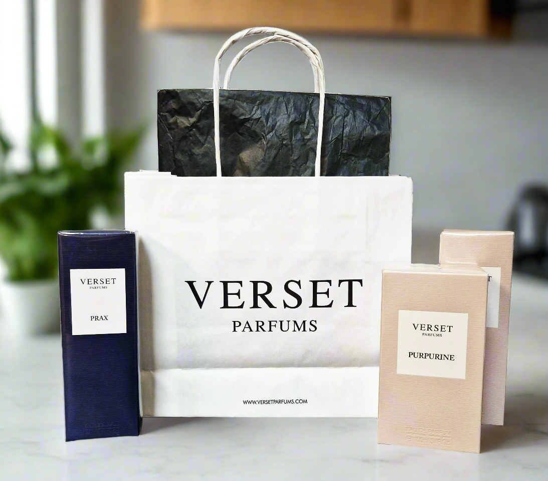 Verset Parfums shopping bag with perfume bottles on a countertop