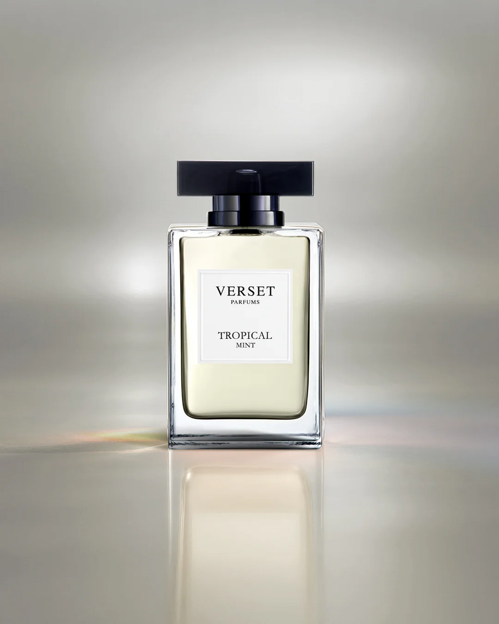 Verset Tropical Mint perfume bottle on a reflective surface with a gradient background