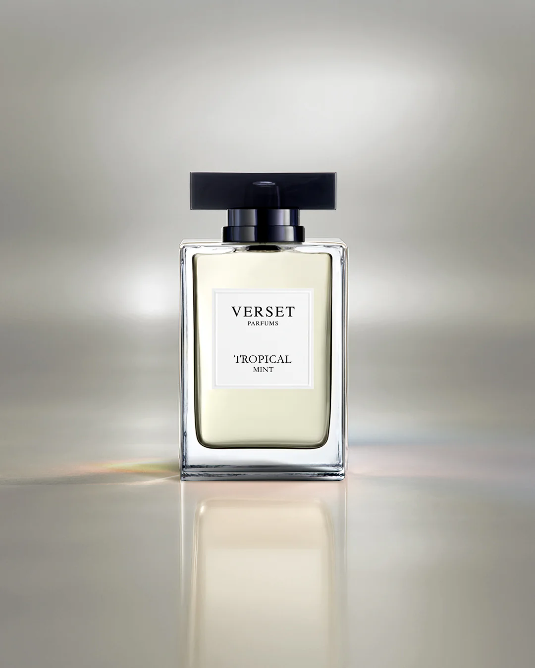 Verset Tropical Mint perfume bottle on a reflective surface with a gradient background